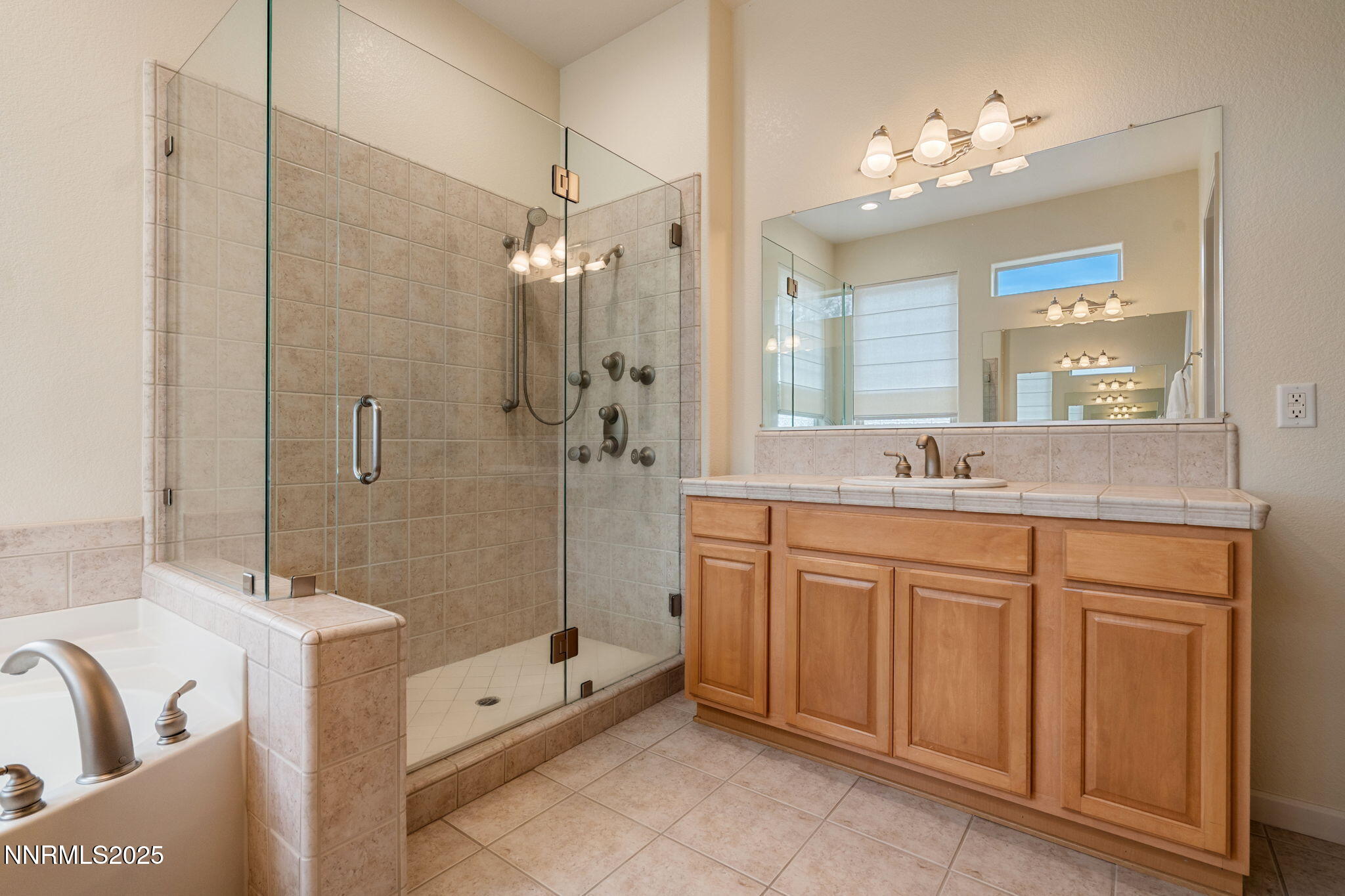 9900 Wilbur May Parkway, Unit 906 Reno, NV 89521 - Photo 26 of 45 a bathroom with a double vanity sink mirror double and shower