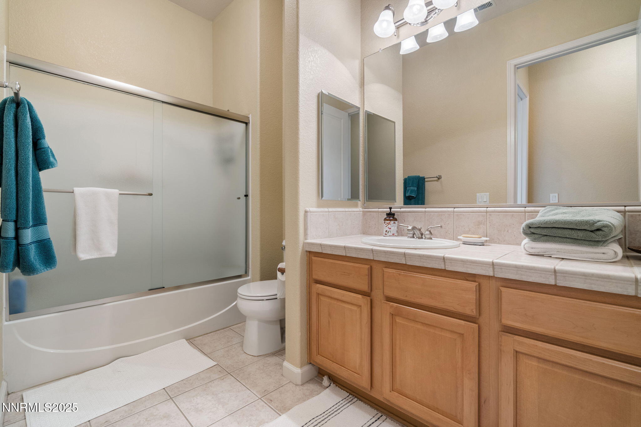 9900 Wilbur May Parkway, Unit 906 Reno, NV 89521 - Photo 28 of 45 a bathroom with a granite countertop sink toilet and shower