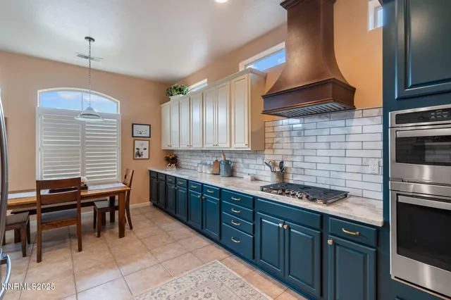 a kitchen with a sink a counter space appliances and cabinets