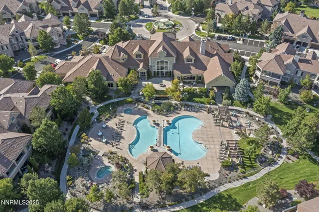 an aerial view of multiple houses with yard