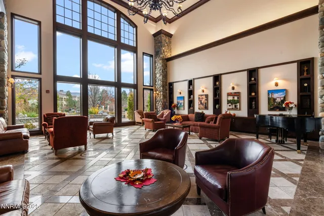 a living room with furniture and a floor to ceiling window