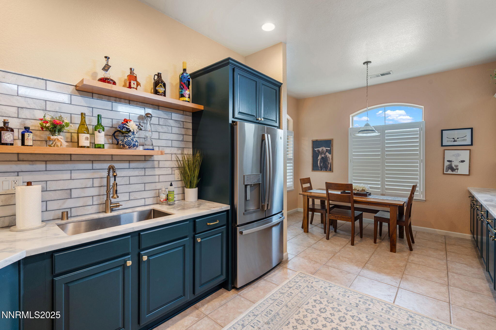 9900 Wilbur May Parkway, Unit 906 Reno, NV 89521 - Photo 6 of 45 a kitchen with granite countertop cabinets a sink a dining table and chairs