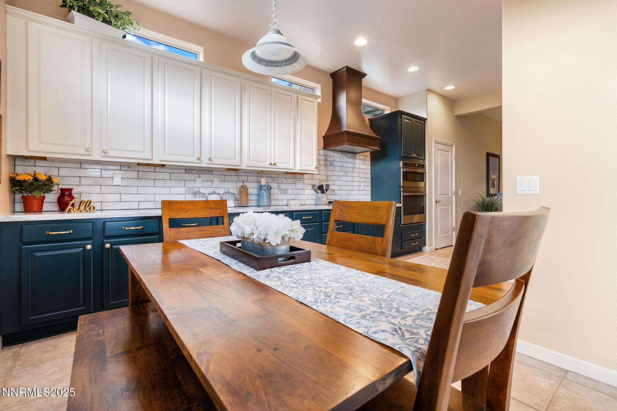9900 Wilbur May Parkway, Unit 906 Reno, NV 89521 - Photo 9 of 45 a kitchen with stainless steel appliances granite countertop table chairs sink and cabinets