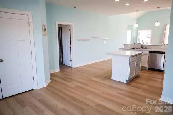 a view of kitchen with granite countertop cabinets and sink
