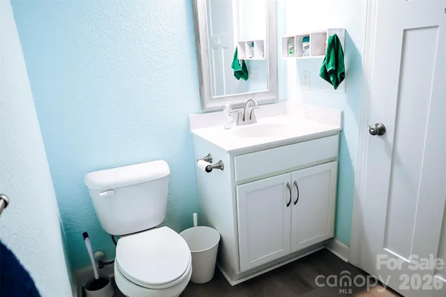 a bathroom with a toilet sink and mirror