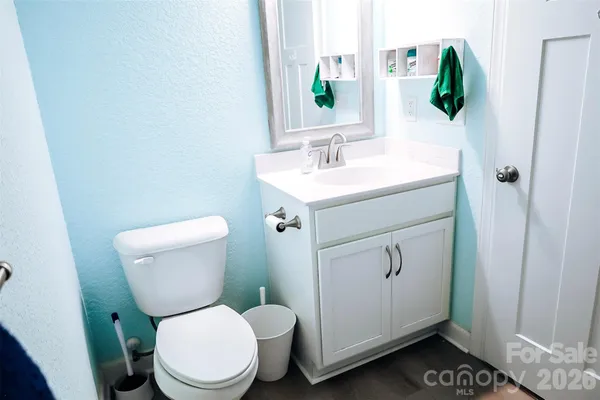 a bathroom with a toilet sink and mirror