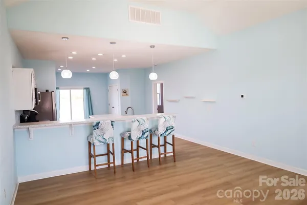 a view of a dining area with furniture and wooden floor