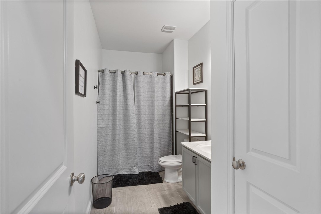 125 Estateside Drive Anderson, SC 29621 - Photo 24 of 37 A pristine bathroom features light gray cabinetry, modern shelving, and neutral flooring.