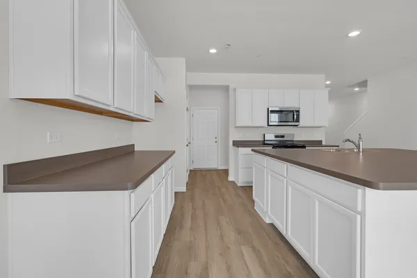 a kitchen with granite countertop a sink and cabinets