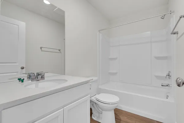 an empty room with closet and a bathroom