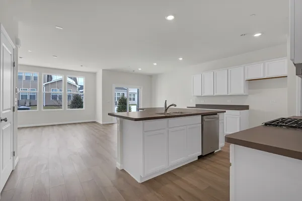 a kitchen with granite countertop a stove top oven and a sink