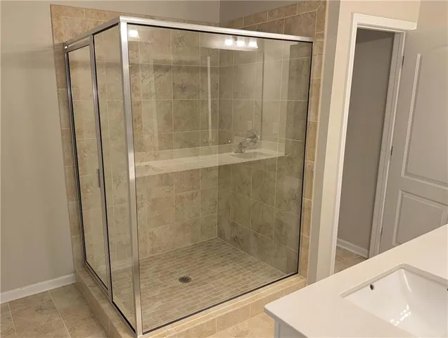 a bathroom with a glass shower door