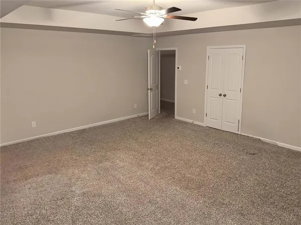 an empty room with a empty space and a ceiling fan
