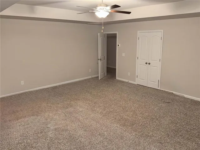 an empty room with a empty space and a ceiling fan