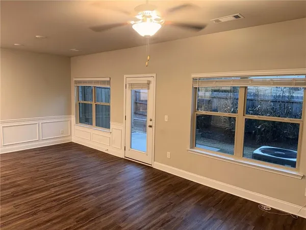 an empty room with wooden floor and fireplace