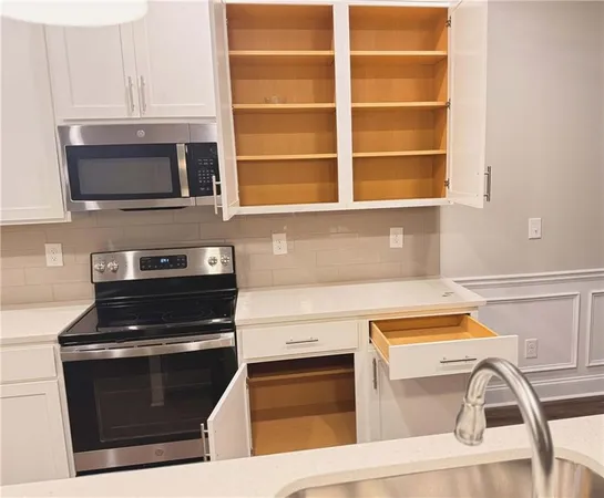 a kitchen with a stove and a microwave