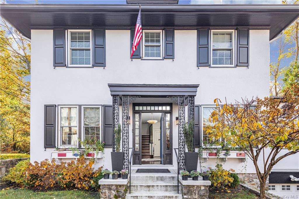 a front view of a house with a garden