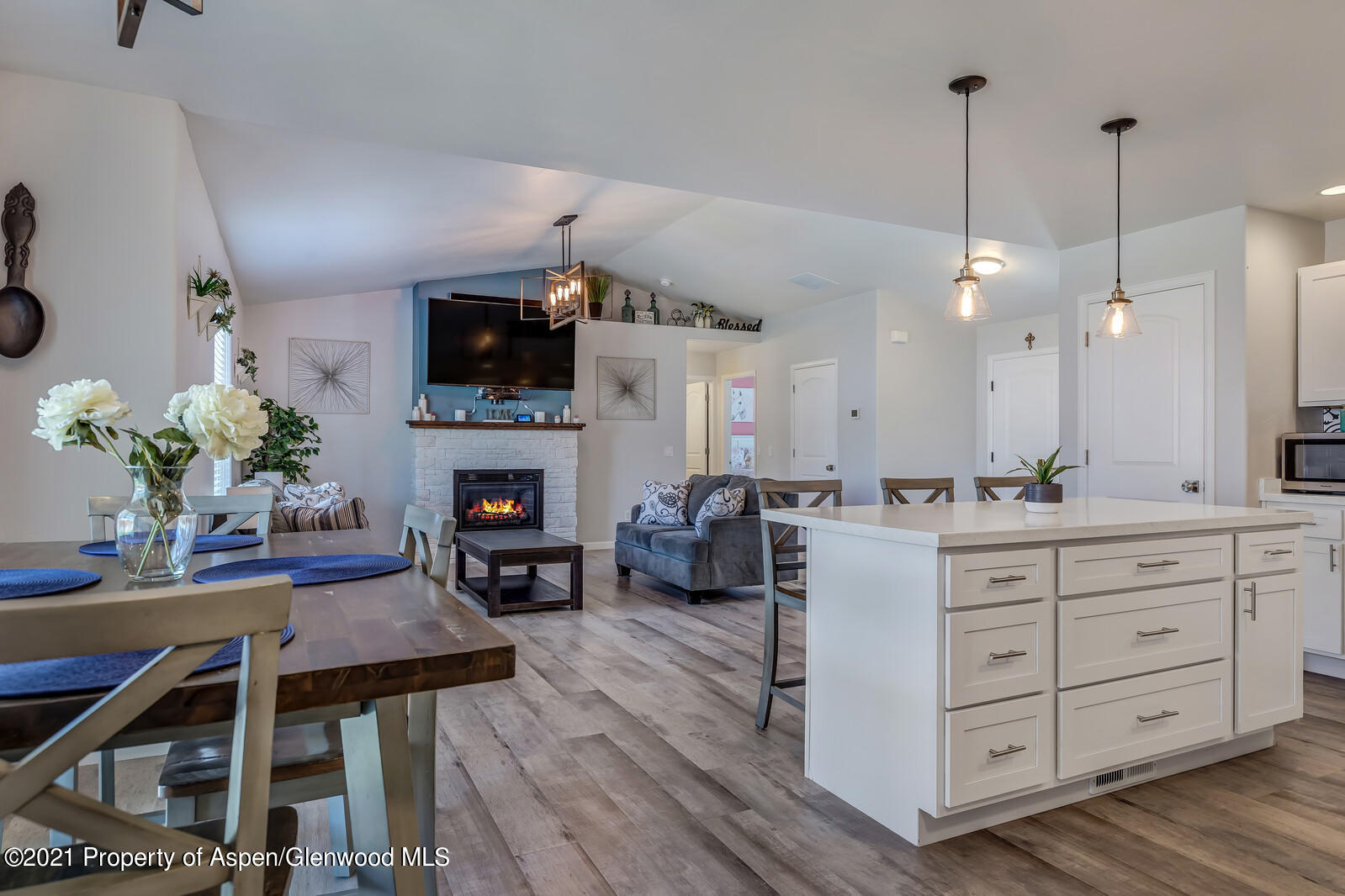 932 East 17th Street Rifle, CO 81650 - Photo 11 of 21 a kitchen with a table chairs refrigerator and microwave