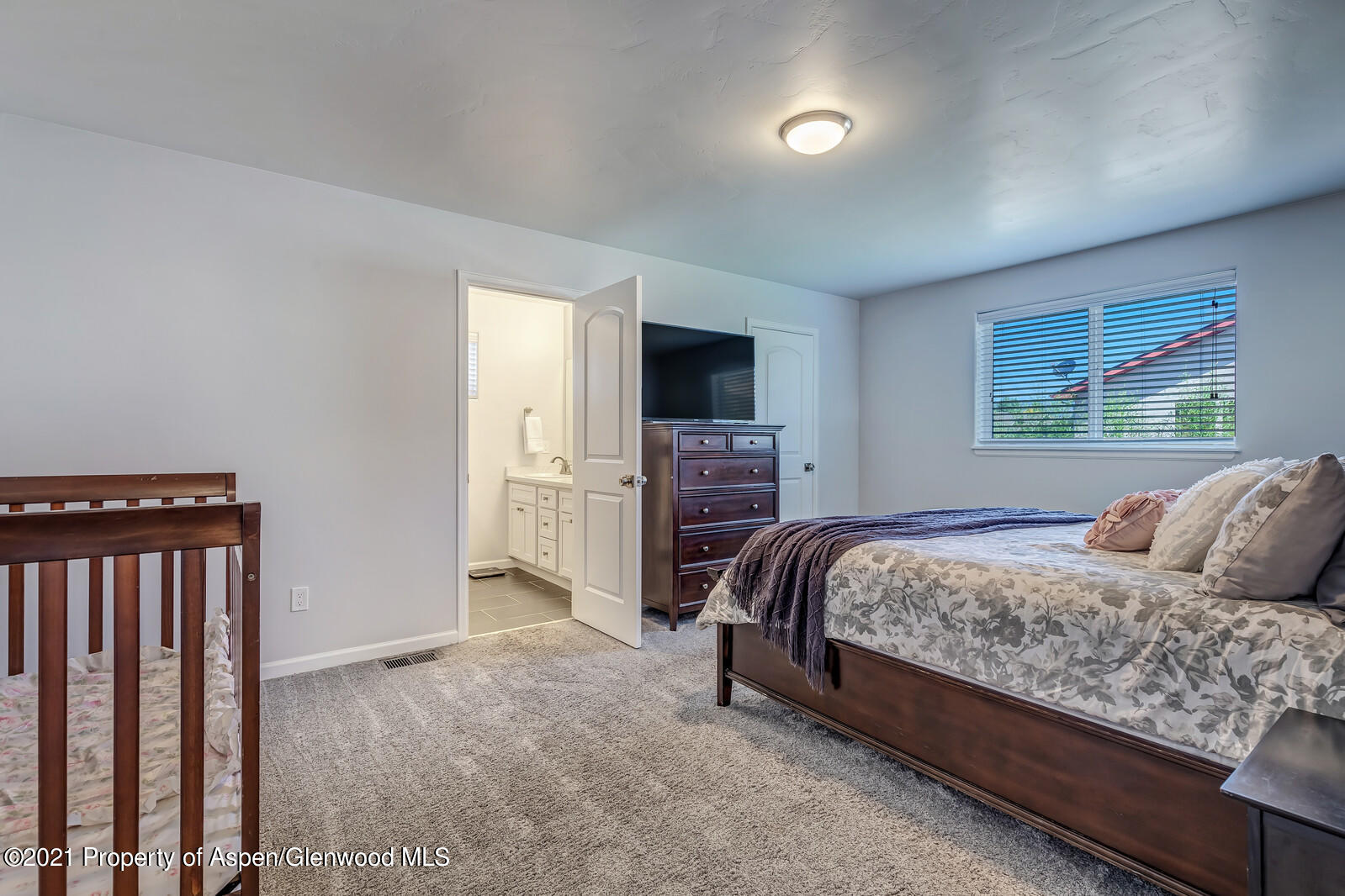 932 East 17th Street Rifle, CO 81650 - Photo 14 of 21 a bedroom with a bed and a television