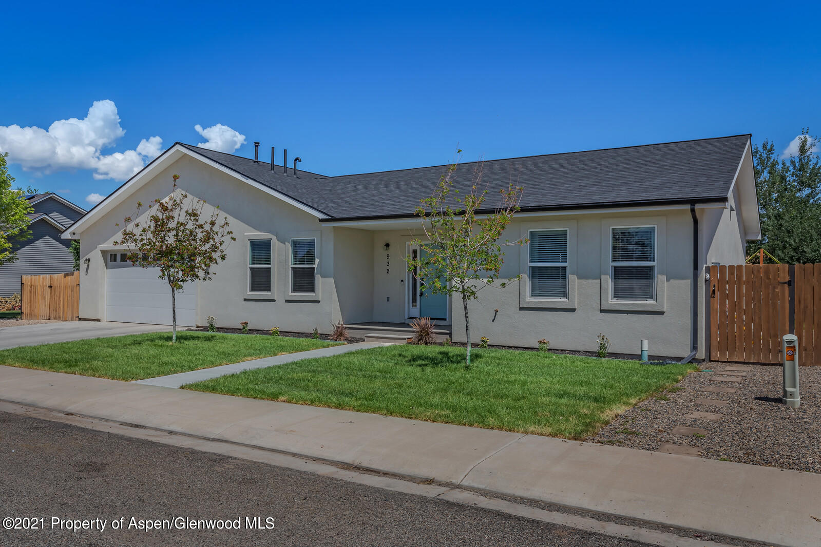 932 East 17th Street Rifle, CO 81650 - Photo 2 of 21 a front view of a house with a yard and garage