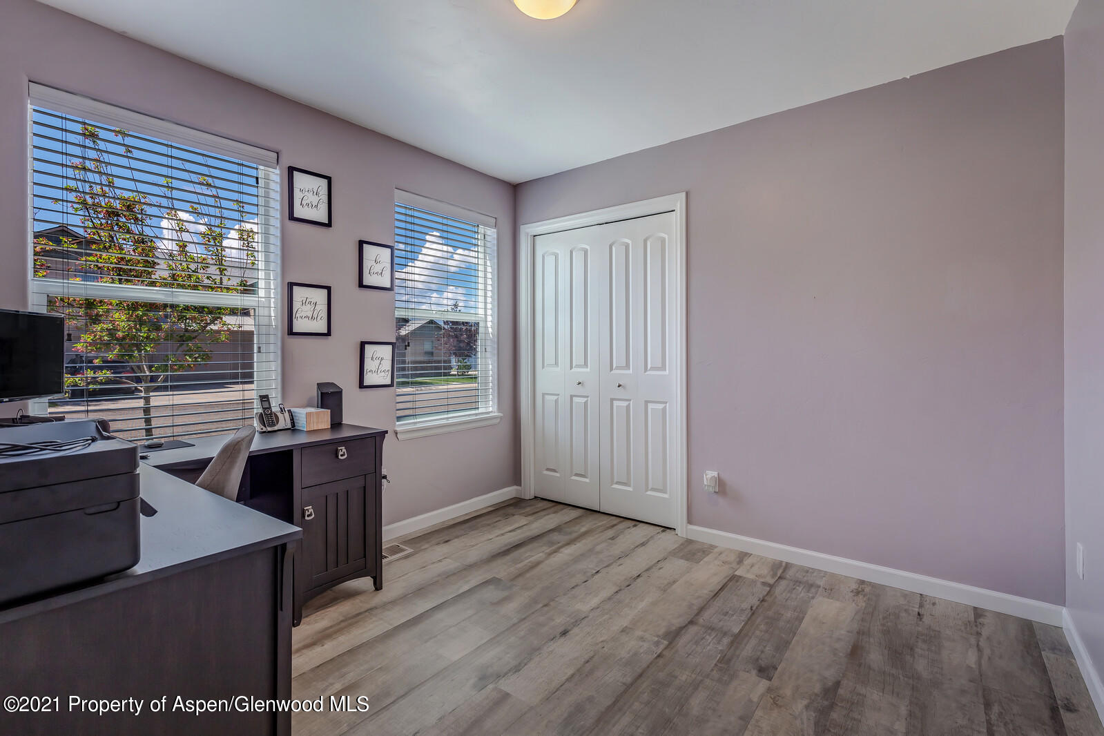 932 East 17th Street Rifle, CO 81650 - Photo 21 of 21 a view of a kitchen and an empty room with wooden floor and windows