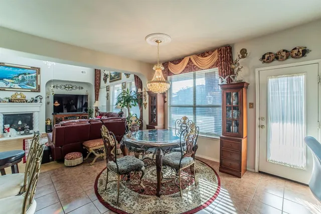 a living room with furniture a fireplace and a table