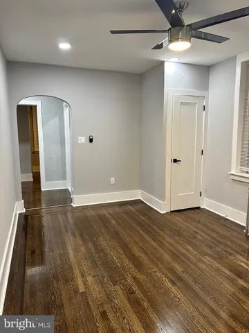 a kitchen with stainless steel appliances a refrigerator stove and white cabinets