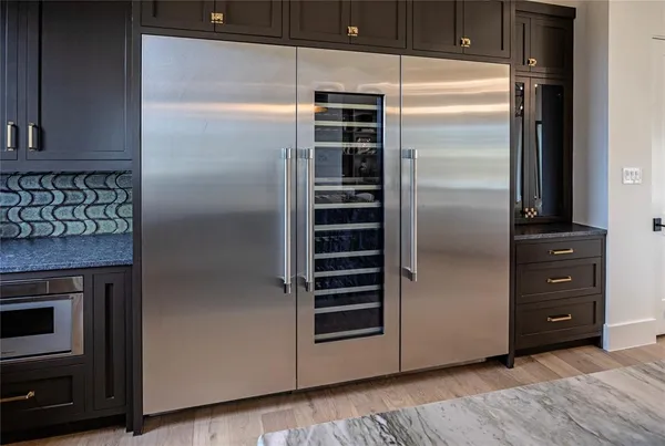 a kitchen with a refrigerator and a stove