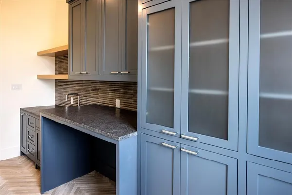 a kitchen with cabinets and a refrigerator