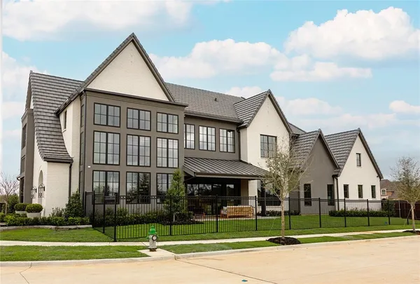 a view of a white house next to a yard