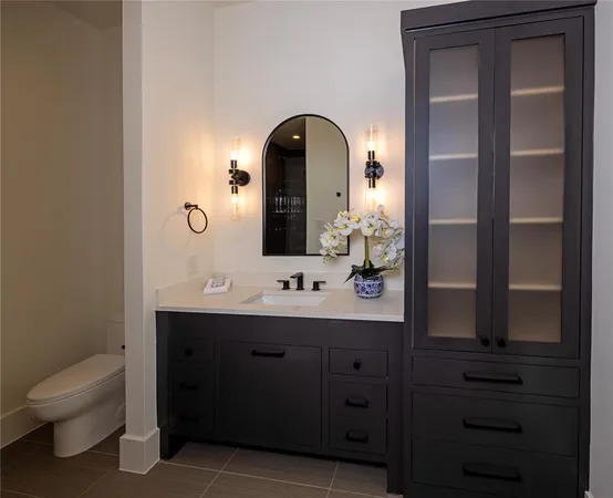 a bathroom with a toilet sink and mirror