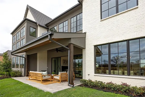a view of a house with backyard porch and sitting area