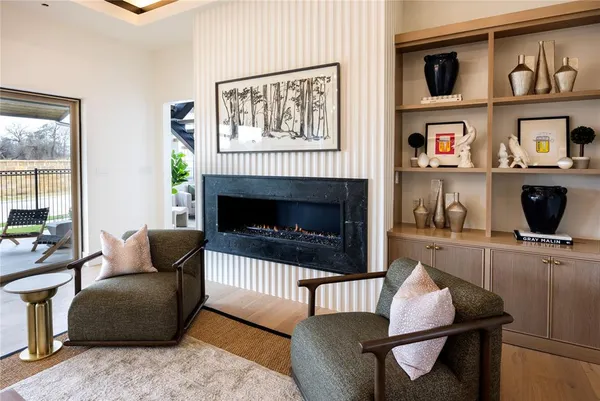 a living room with furniture a rug and a fireplace