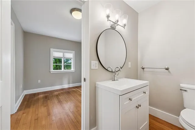 a bathroom with a toilet a sink and a mirror
