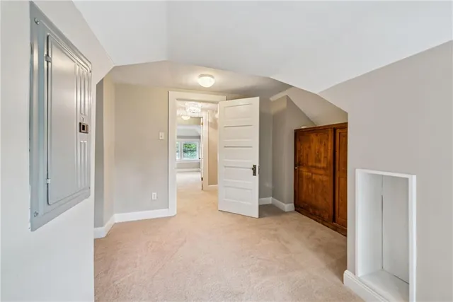 an empty room with windows and closet