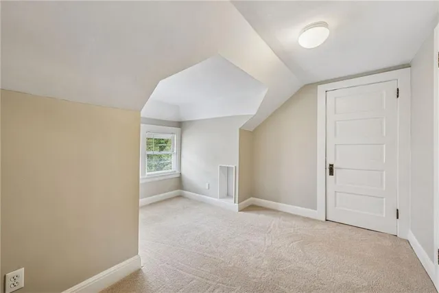 an empty room with a cabinet and a refrigerator