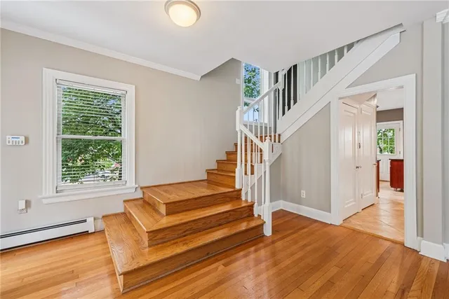 a view of entryway and hall with wooden floor