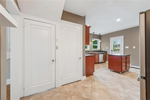 a view of a kitchen with a refrigerator and a sink