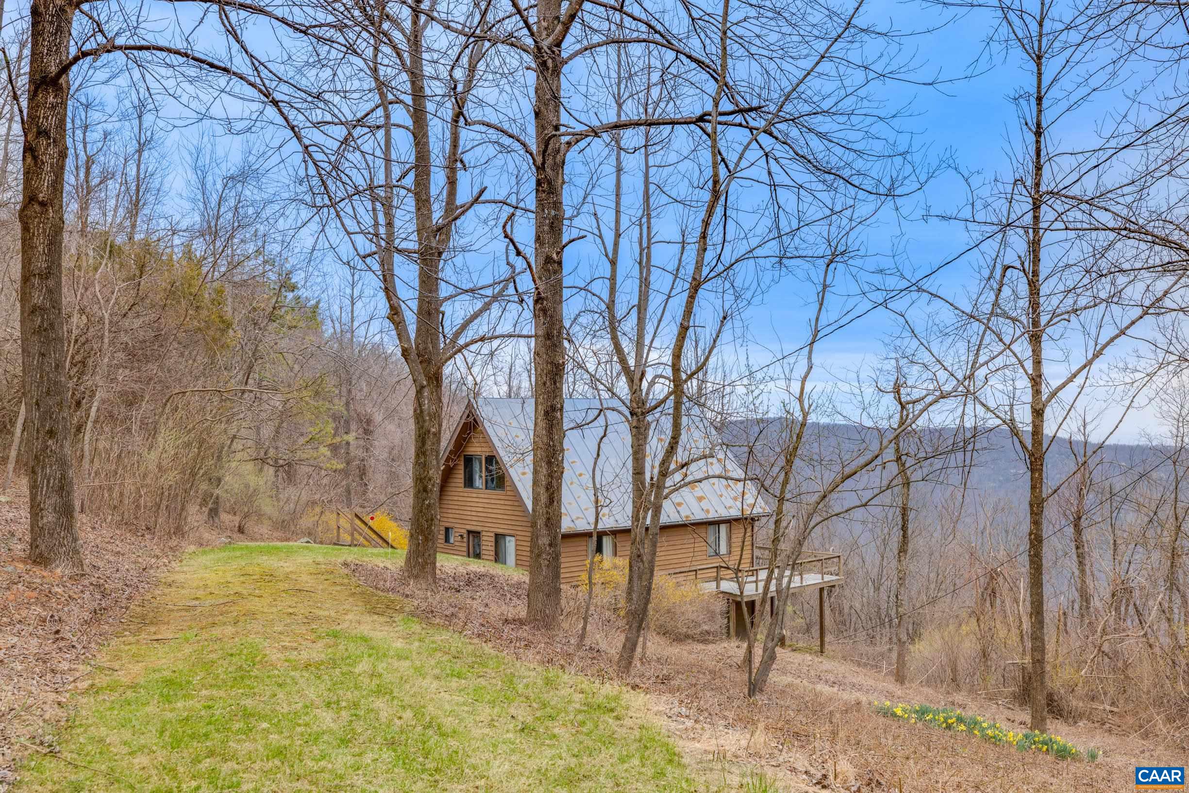 3728 Flattop Mountain Road Free Union, VA 22940 - Photo 14 of 17 a backyard of a house with table and chairs