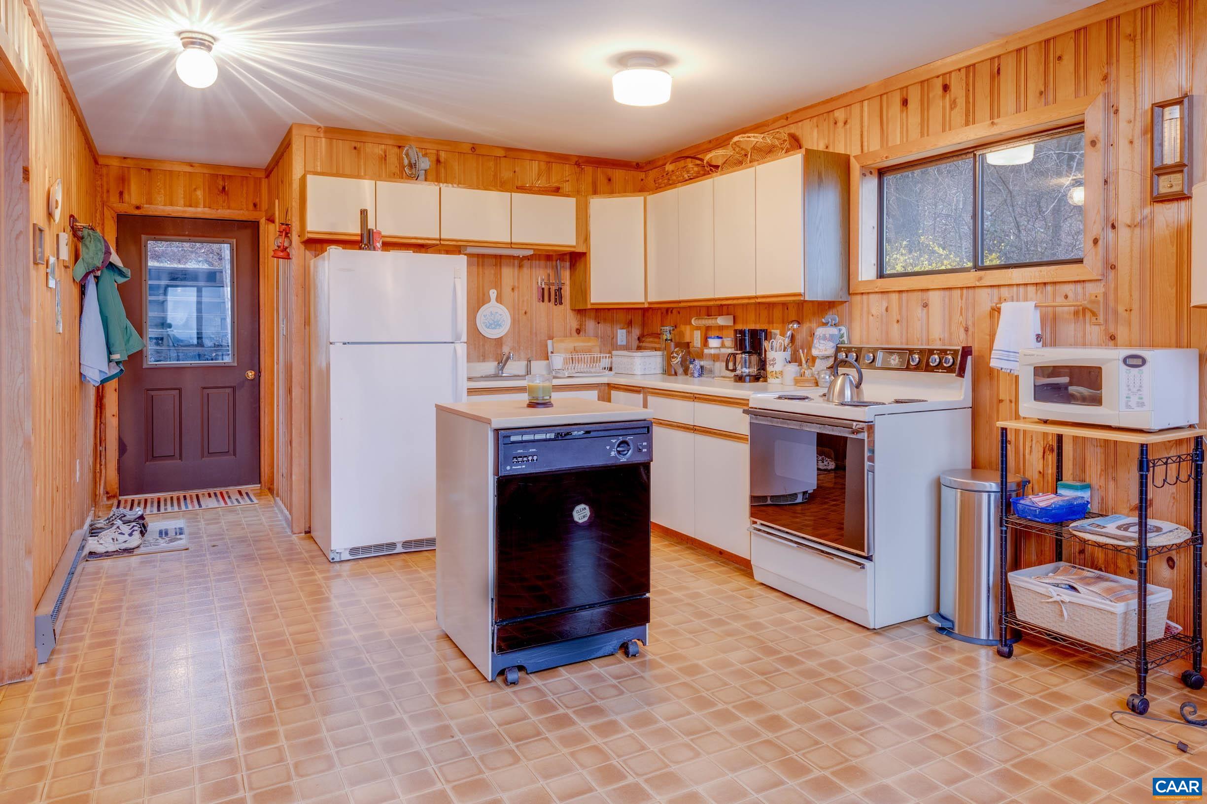 3728 Flattop Mountain Road Free Union, VA 22940 - Photo 7 of 17 a kitchen with stainless steel appliances granite countertop a stove top oven a sink dishwasher and cabinets with wooden floor