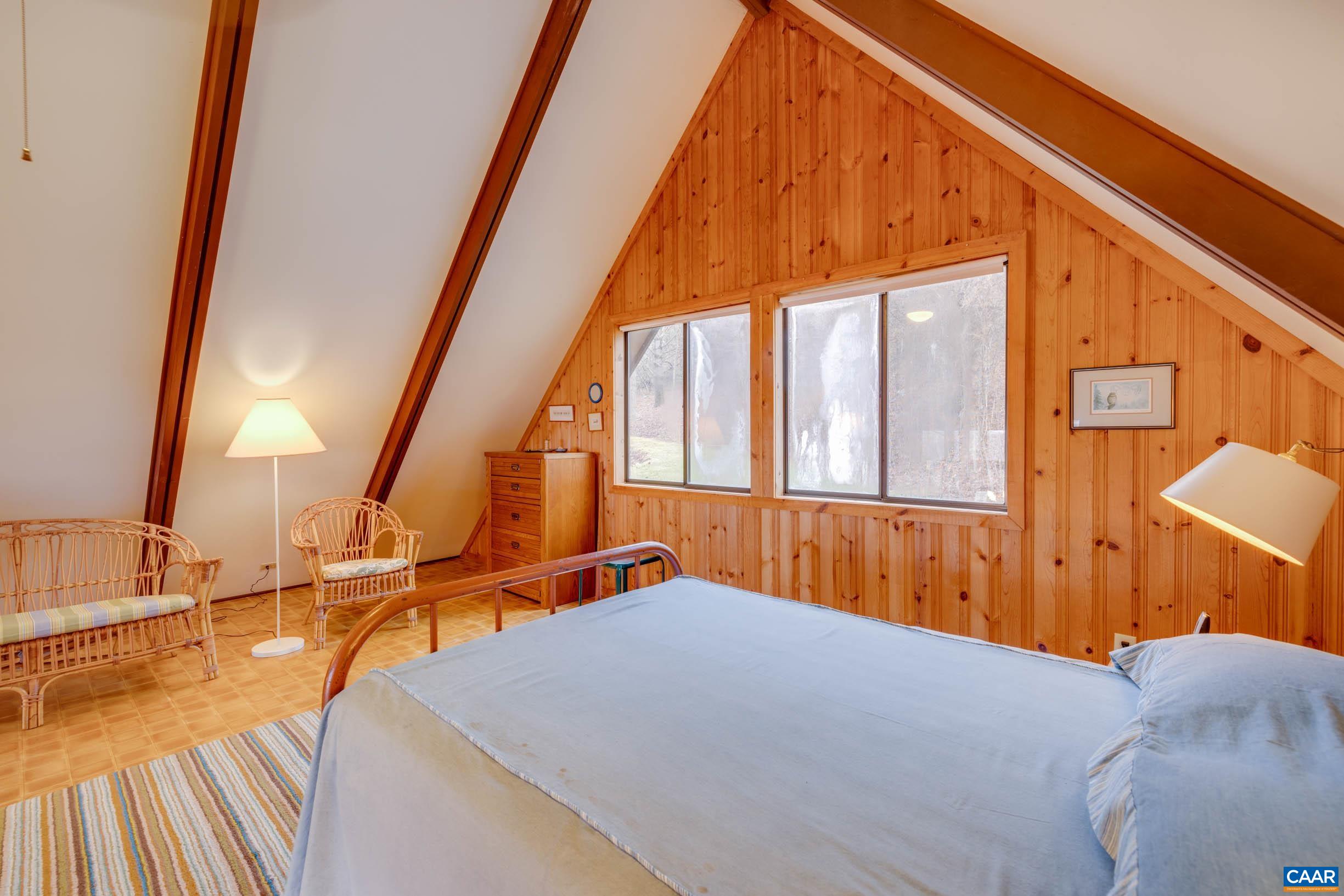 3728 Flattop Mountain Road Free Union, VA 22940 - Photo 9 of 17 a view of a bedroom with wooden floor and furniture