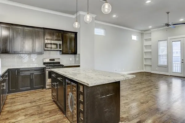 a kitchen with a stove a sink and a refrigerator