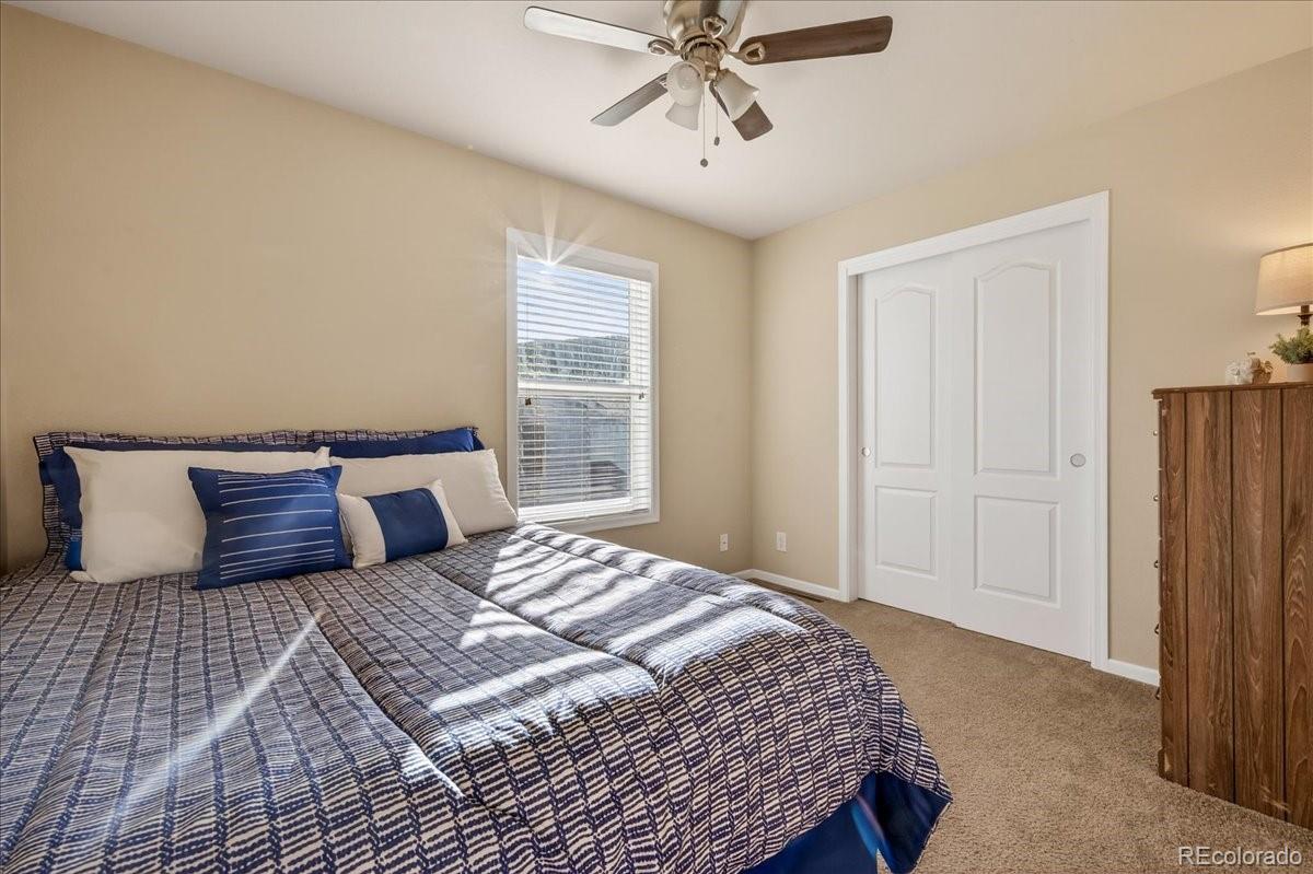 53 Brook Trout Loop Gypsum, CO 81637 - Photo 23 of 38 a bedroom with a large bed and a chandelier