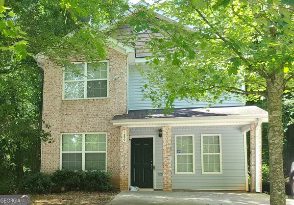 a front view of a house with a garden
