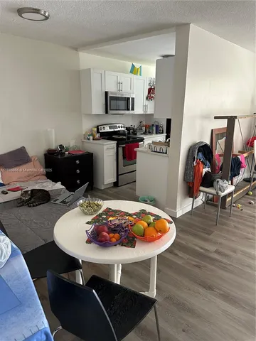 a kitchen with a table chairs and a stove