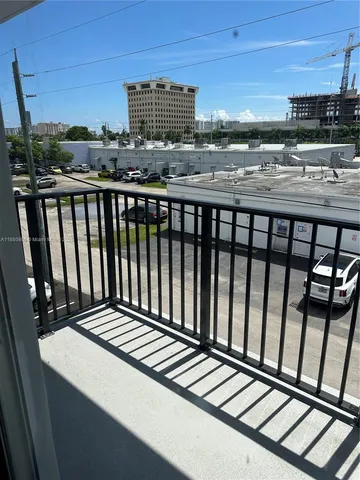 a view of a balcony with wooden floor