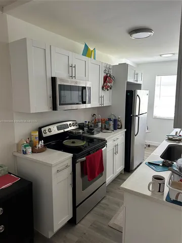 a kitchen with a sink stove and refrigerator