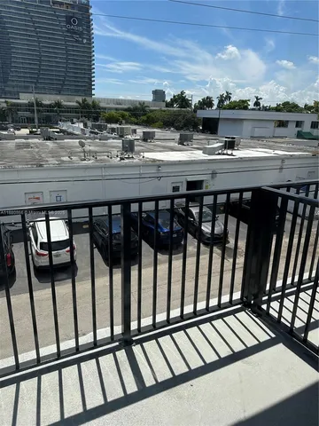 a view of balcony with wooden floor and city view