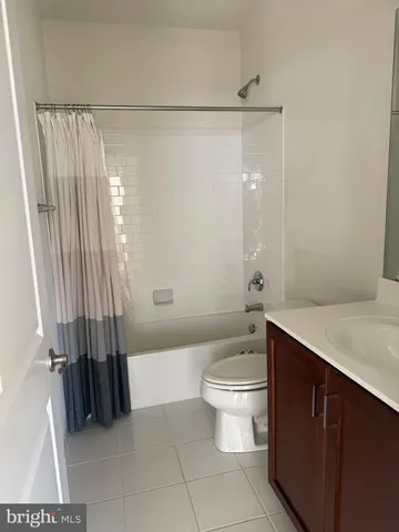 a bathroom with a sink a toilet a tub and shower