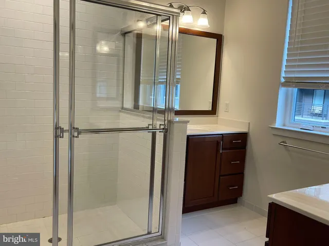 a bathroom with a mirror and a shower